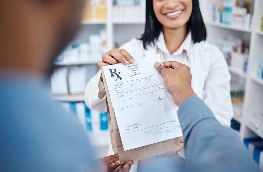 Woman giving prescription under new medicare compliance rules