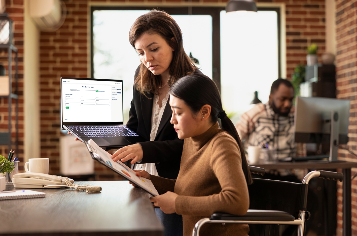 office workers reviewing laptop tpa